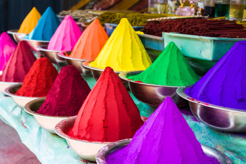 Rows of Colored dye in bowls for festivals.